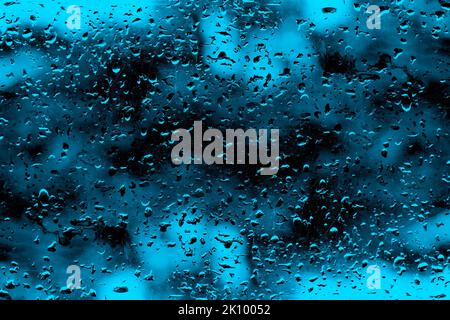 Crystal royal blue water drops on the blurry glass for texture background Stock Photo