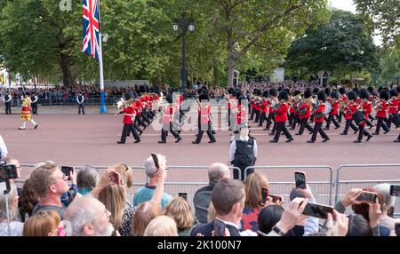 The Mall, London, UK. 14 September 2022. The Band of The Scots Guards, with black shrouded drums, play a solemn march at the head of The funeral procession for Queen Elizabeth II moves along The Mall from Buckingham Palace to Westminster Hall where Queen Elizabeth’s body will lie in State until Monday 19 September. Credit: Malcolm Park/Alamy Live News. Stock Photo