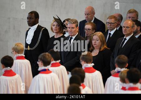 Prime Minister Liz Truss (2nd from left) and Sir Keir Starmer (3rd from left) watch as the bearer party carries the coffin of Queen Elizabeth II into Westminster Hall, London, where it will lie in state ahead of her funeral on Monday. Picture date: Wednesday September 14, 2022. Stock Photo