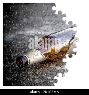 Broken bottle of beer resting on the ground - Free themselves from alcohol addiction - concept image in jigsaw puzzle shape Stock Photo