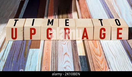 TIME TO UPGRADE written on wooden cubes and vintage background Stock Photo