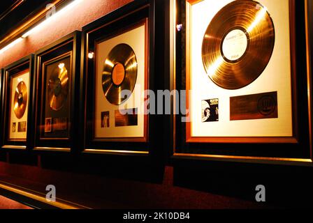 Framed gold records earned by singer and musician Elvis Presley hang on the wall in a museum on the grounds of his Graceland in Memphis Tennessee Stock Photo