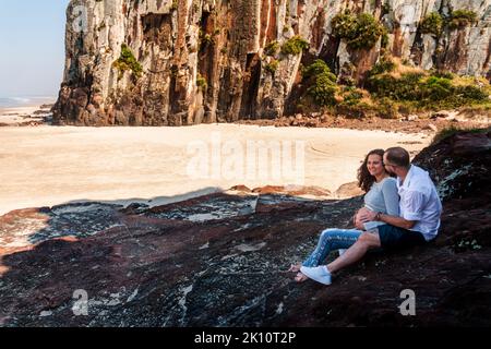 Pregnant couple in love dancing at sunset on the platform of Praia dos Molhes in Torres in Rio Grande do Sul. Stock Photo