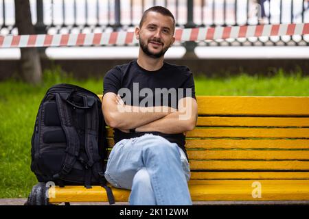 Caucasian man sits on a bench Stock Photo