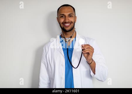 Portrait of cheerful arab doctor holding stethoscope Stock Photo