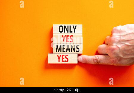 Only yes means yes symbol. Concept words Only yes means yes on wooden blocks on a beautiful orange table orange background. Businessman hand. Business Stock Photo