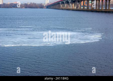Thin ice floe drifts downstream in springtime Stock Photo