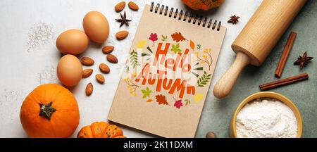 Notebook and ingredients for pumpkin pie on color background Stock Photo