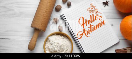 Notebook and ingredients for pumpkin pie on white wooden background, top view Stock Photo