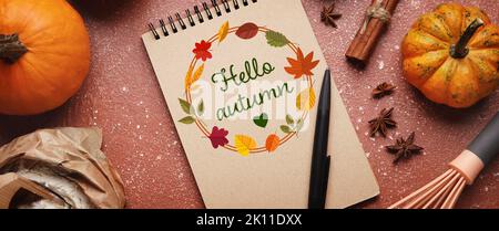Notebook and ingredients for pumpkin pie on color background Stock Photo