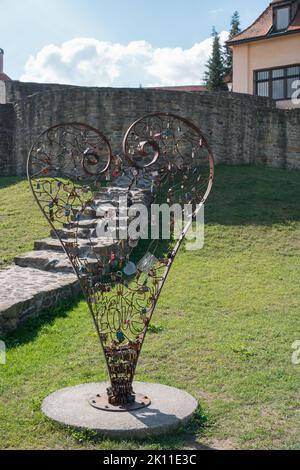 Lockers of love in Bardejov city, Slovakia. Near singing fountain is big metal heart where people can lock their love with lockers. Stock Photo