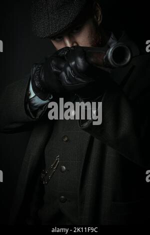 A working class Victorian man with red hair and beard against a black backdrop Stock Photo