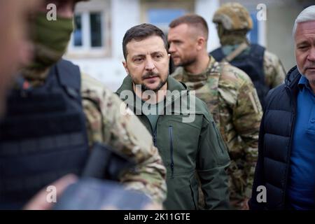 Izium, Ukraine. 14th Sep, 2022. Ukrainian President Volodymyr Zelenskyy, speaks with residents and views destruction during a visit to the recaptured region, September 14, 2022 in Izium, Kharkiv region, Ukraine. Zelensky made a surprise visit to the city recaptured from Russia during a Ukrainian counteroffensive. Credit: Ukrainian Presidential Press Office/Ukraine Presidency/Alamy Live News Stock Photo