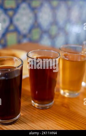 Tasting of different sweet wines from wooden barrels on old bodega wine bar in central part of Malaga, Andalusia, Spain Stock Photo