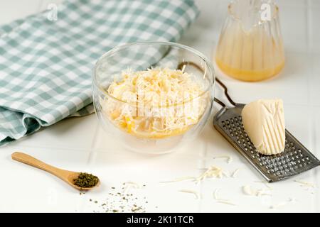 Creamy Corn with Grated Cheese, on White Table Stock Photo