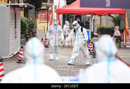 GUIYANG, CHINA - SEPTEMBER 15, 2022 - Epidemic prevention personnel disinfect an area for nucleic acid sampling in Guiyang, Guizhou province, China, S Stock Photo