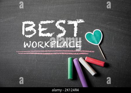 BEST WORKPLACE. Text on black chalk board. Stock Photo