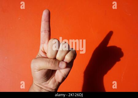 signs with various hand gestures on a red background Stock Photo