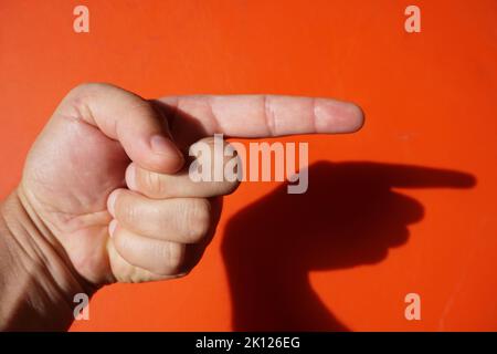 signs with various hand gestures on a red background Stock Photo