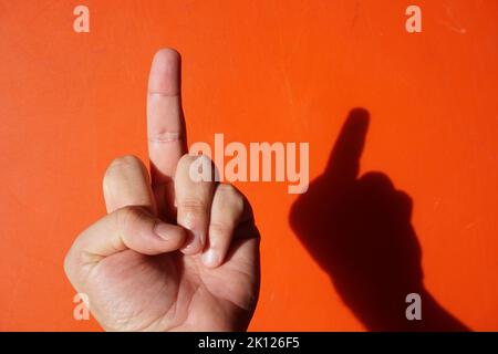signs with various hand gestures on a red background Stock Photo