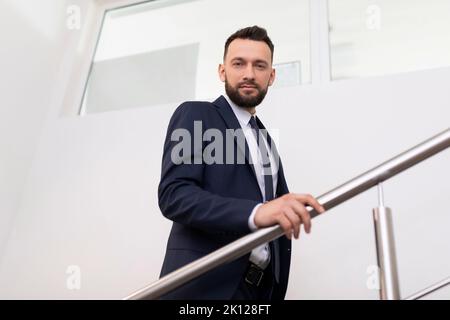 presentable man in a business suit on the landing in the office, Concept of a modern entrepreneur Stock Photo