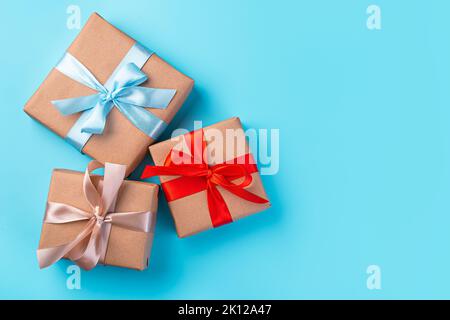 Gift boxes with colored ribbons on a blue background. Stock Photo