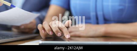Business people talking using digital tablet sitting at office table Stock Photo