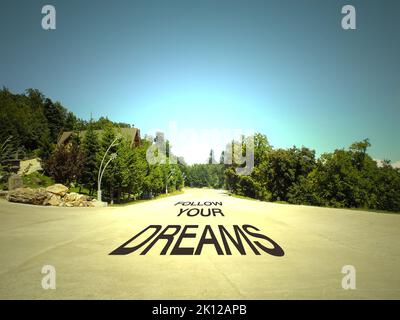 Follow your dreams written on a road in the middle of empty road and beautiful landscape concept. Stock Photo