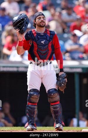 Cleveland Guardians catcher Austin Hedges runs after a wide throw to home plate during the