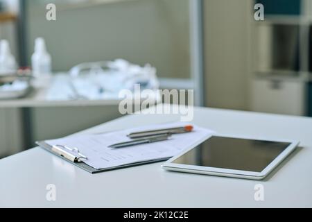 Close-up of digital tablet with medical card lying on table of doctor at office Stock Photo