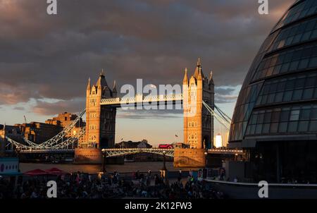 London, England Uk - August 5, 2022: Panorama of the More London Riverside and people enjoying a music festival on the Thames riverside at sunset Stock Photo