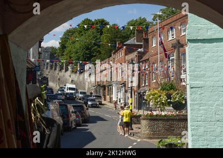 View up the High Street in Arundel, West Sussex, England. With people walking around. Stock Photo