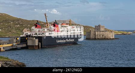 CalMac Ferry moored beneath Kisimul Castle, Castlebay, Barra, Isle of Barra, Hebrides, Outer Hebrides, Western Isles, Scotland, United Kingdom Stock Photo