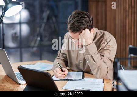 employees working in the office until late at night. Stock Photo