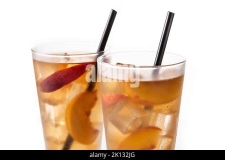 Glass of peach tea with ice cubes isolated on white background Stock Photo