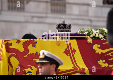 Imperial State Crown on a purple velvet cushion is laid upon Queen's coffin draped with the Royal Standard as it was carried on a gun carriage from Buckingham Palace at Queen's Ceremonial Procession. Stock Photo