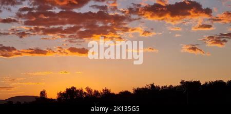 The clouds are illuminated by the red light of the sunset Stock Photo