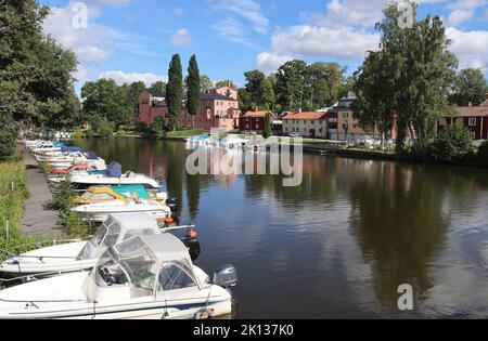 Summer view of the waterfront buildings and boat harbour at Askersund in Sweden. Askersund is a picturesque town situated at the far northern end of L Stock Photo