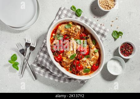 chicken legs backed with feta cheese tomatoes and pine nuts, healthy meal Stock Photo