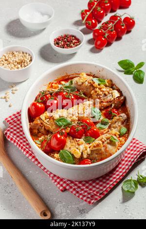 chicken legs backed with feta cheese tomatoes and pine nuts, healthy meal Stock Photo