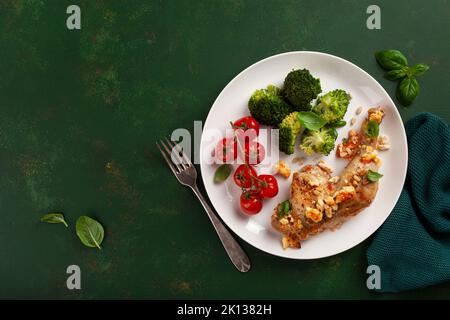 chicken legs backed with feta cheese tomatoes and broccoli, healthy keto meal Stock Photo