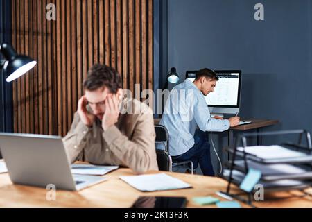 tired businessman working with documents late at night . Stock Photo