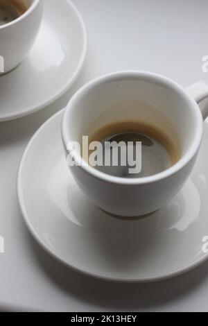 Espresso Coffee in White Ceramic Cups on White Background. Cafe. Stock Photo