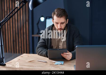 business man using a digital tablet during night work in the office. Stock Photo