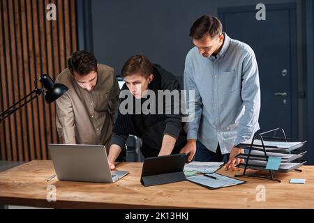 business team working works in the office late at night. Stock Photo
