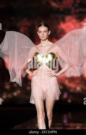 A model walks the runway wearing a creation of  Andres Sarda during the presentation collection 'CINEMA ' at Mercedes-Benz Fashion Week Madrid. Stock Photo