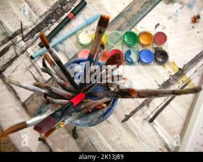 A top view of paint brushes in a jar on a table Stock Photo