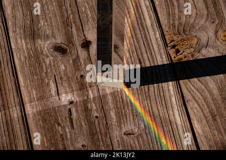 A futuristic cool background with glass prisms and light shadows on a wooden surface Stock Photo