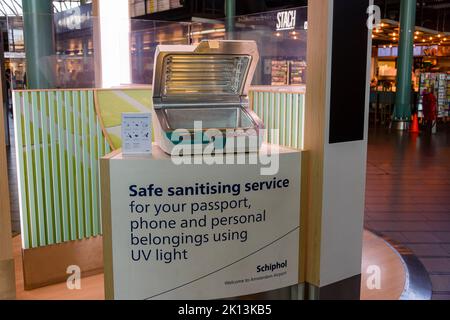 Free to use sanitising station, which uses ultra violet light and ozone to sterilise small items such as mobile phones, passports and other personal belongings, Schiphol Airport, Netherlands Stock Photo