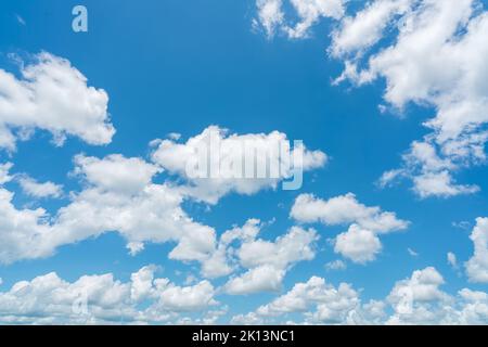 Beautiful blue sky and white cumulus clouds abstract background. Cloudscape background. Blue sky and fluffy white clouds on sunny day. Nice weather. Stock Photo
